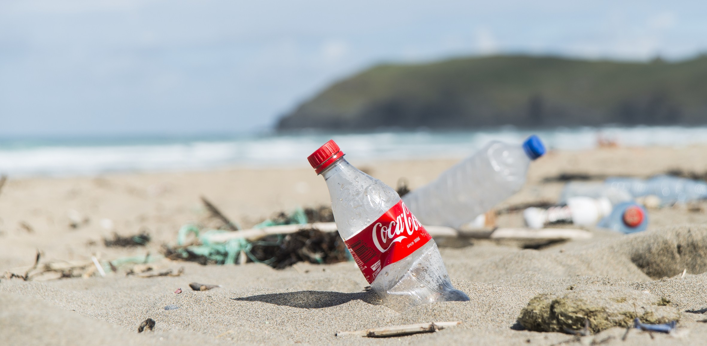 Coke bottle in sand