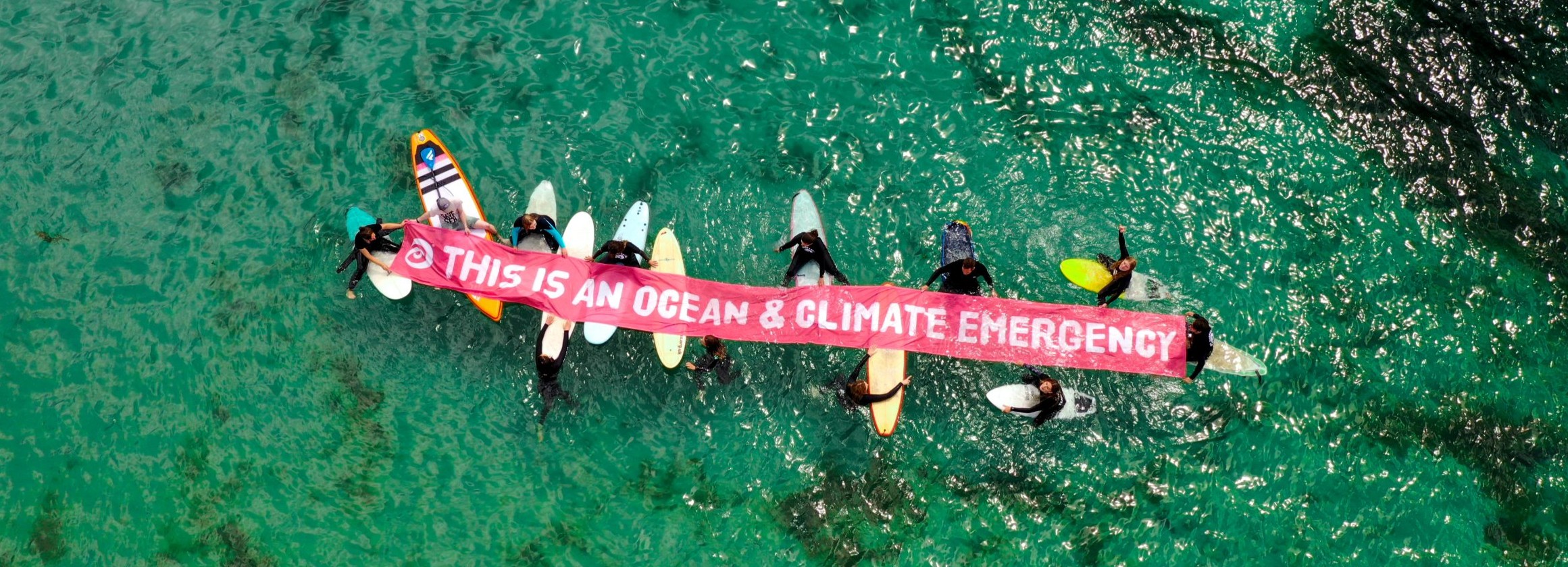 Ocean and climate emergency banner in the water