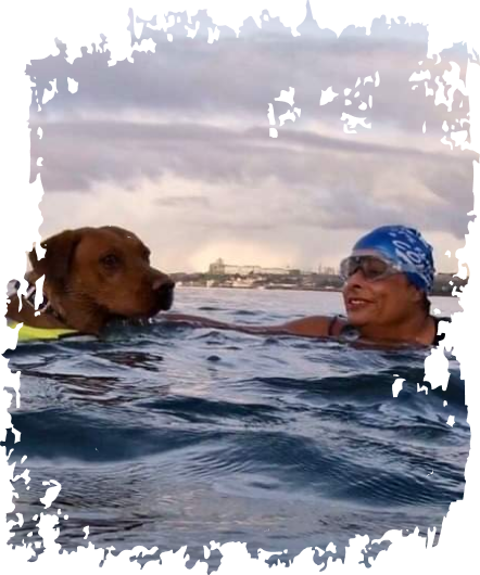 woman swimming with dog