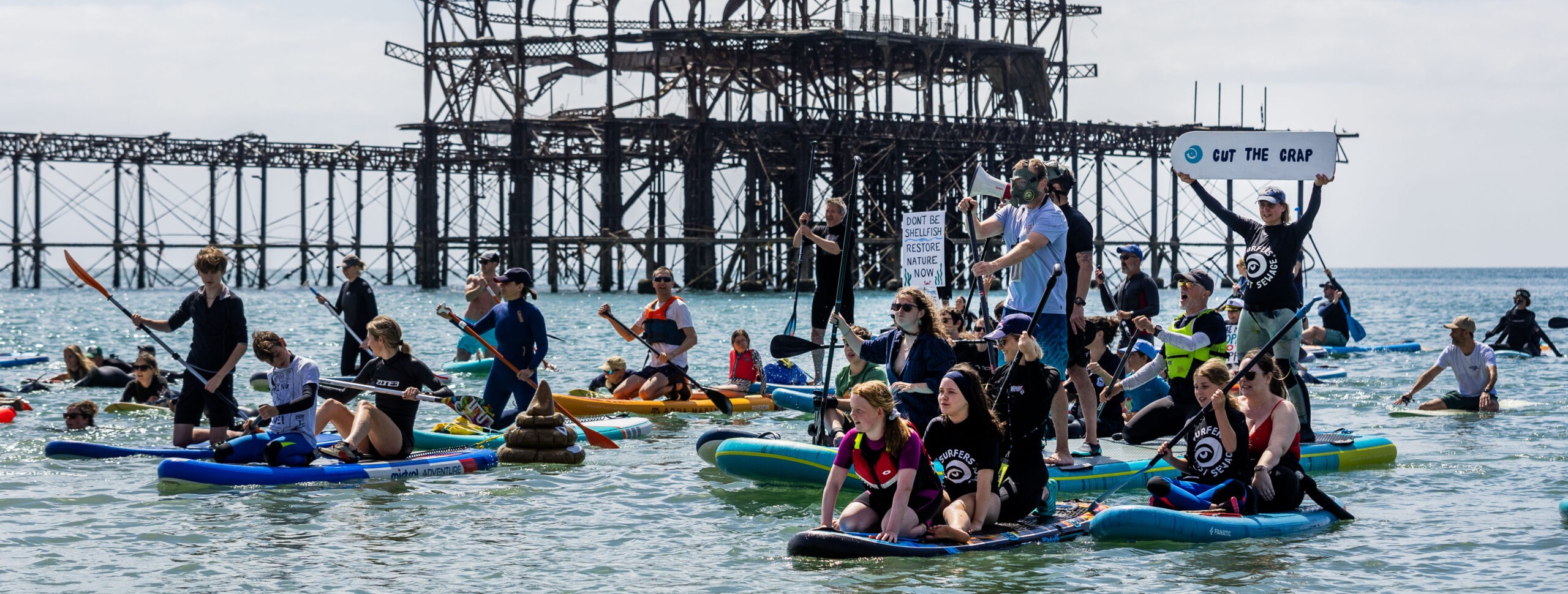 Paddle boarders at a paddle out protest