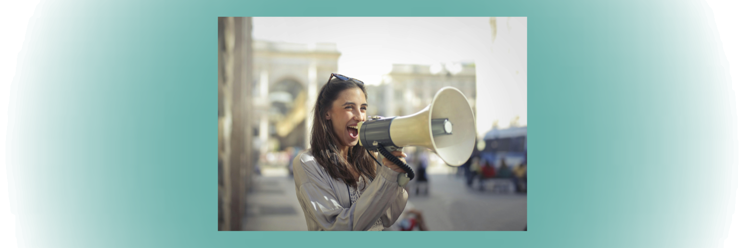 Woman speaking into a loudhailer