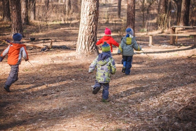 A group of children running in the woods