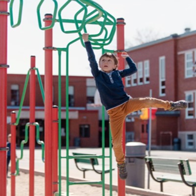 Young child playing on a climbing frame