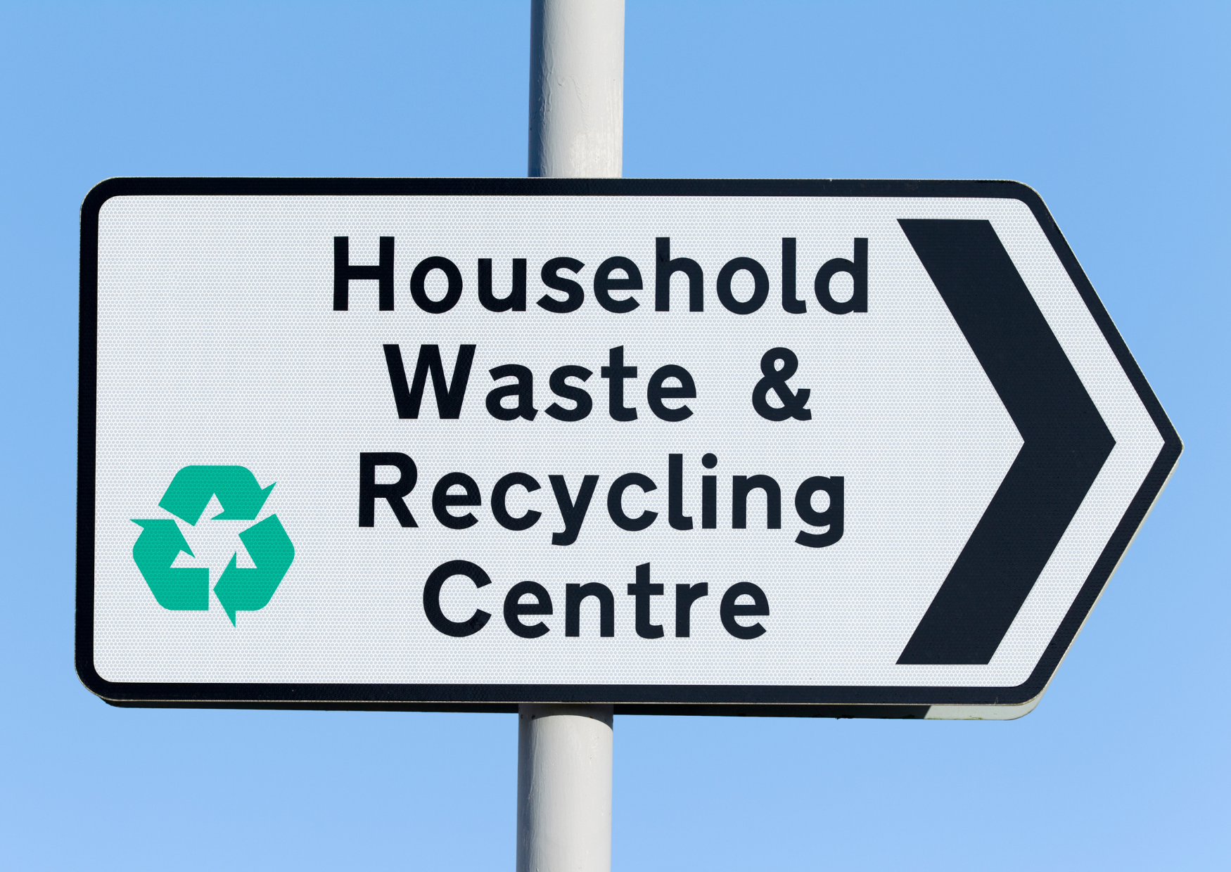 Image of a road sign. The text reads household waste and recycling centre