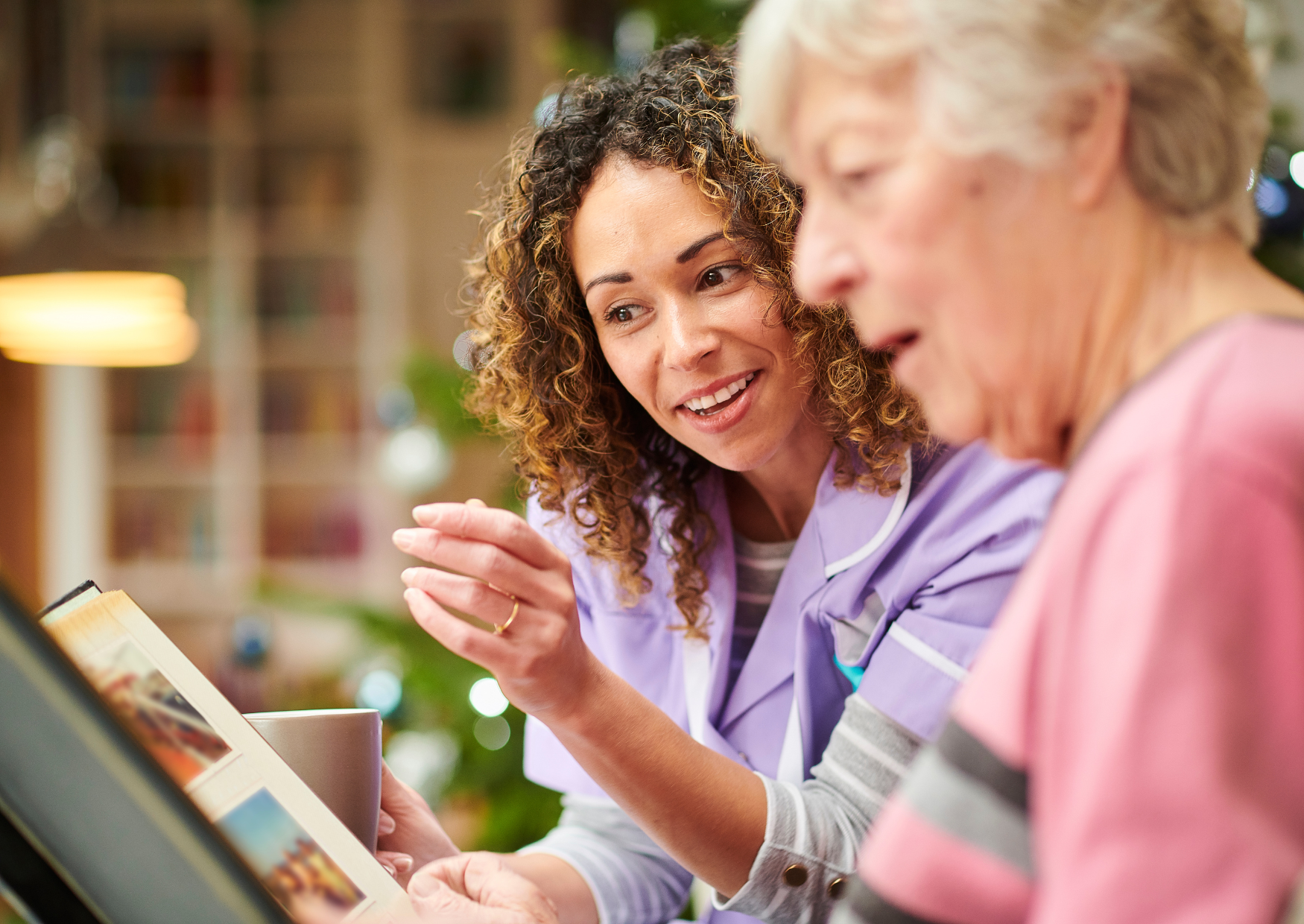 Older person reading with their carer