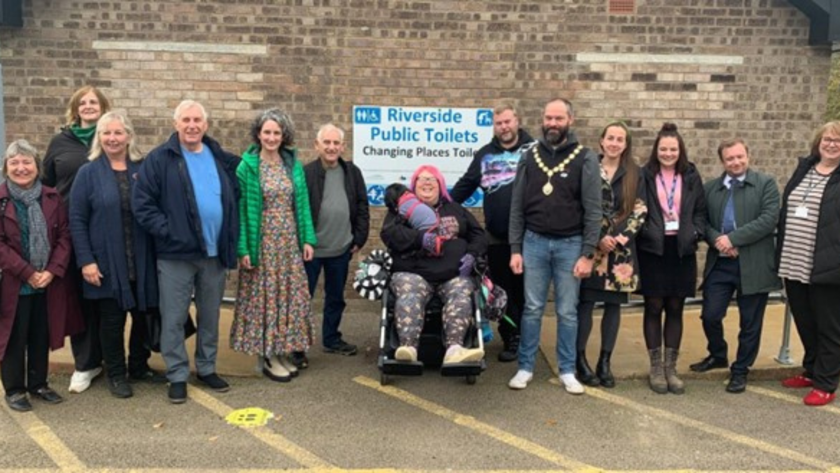 Image of a group of people stood outside of Riverside public toilets