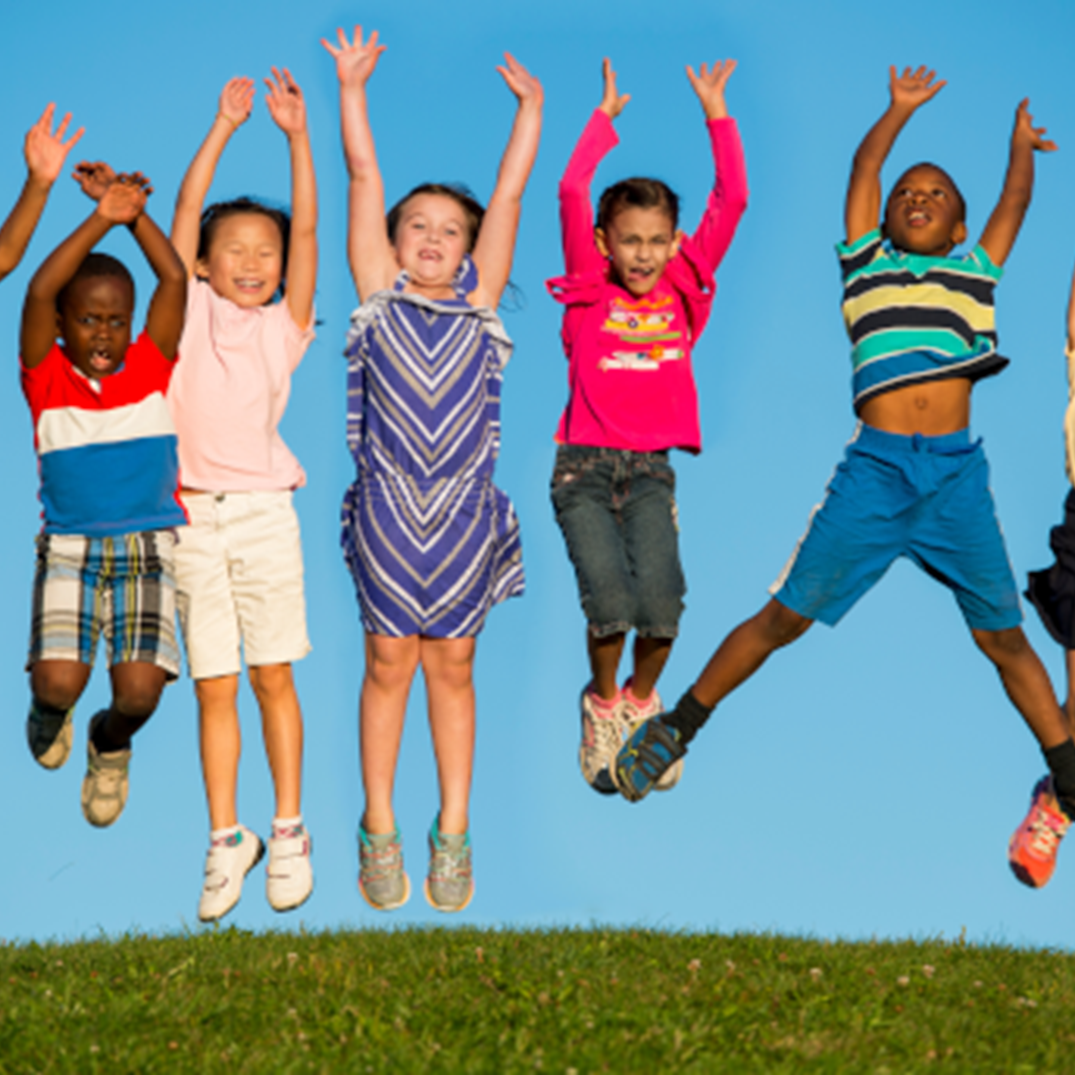 children outside jumping in the air