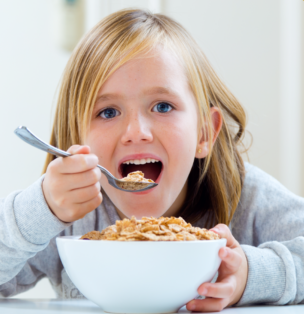 A child eating cereal with a spoon