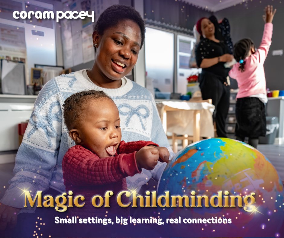 A child and an adult engaging with a colourful globe in an indoor learning environment, with other children and adults interacting in the background