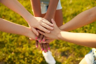 A group of people putting their hands together