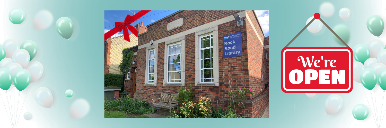 Image of Rock Road library surrounded by balloons and a sign saying 'We're Open'