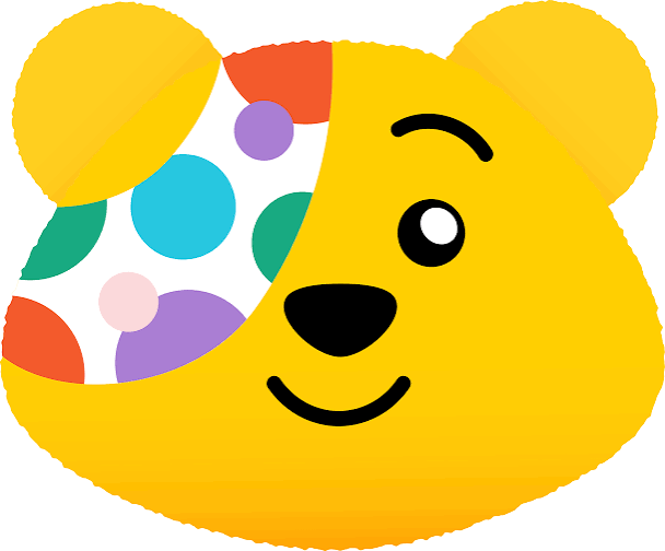 Cartoon illustration of Pudsey Bear, the cheerful yellow mascot for BBC Children in Need, designed as a playful celebratory graphic. Black smiling facial features, white-highlighted eye, and iconic colourful poker dot eyepatch.