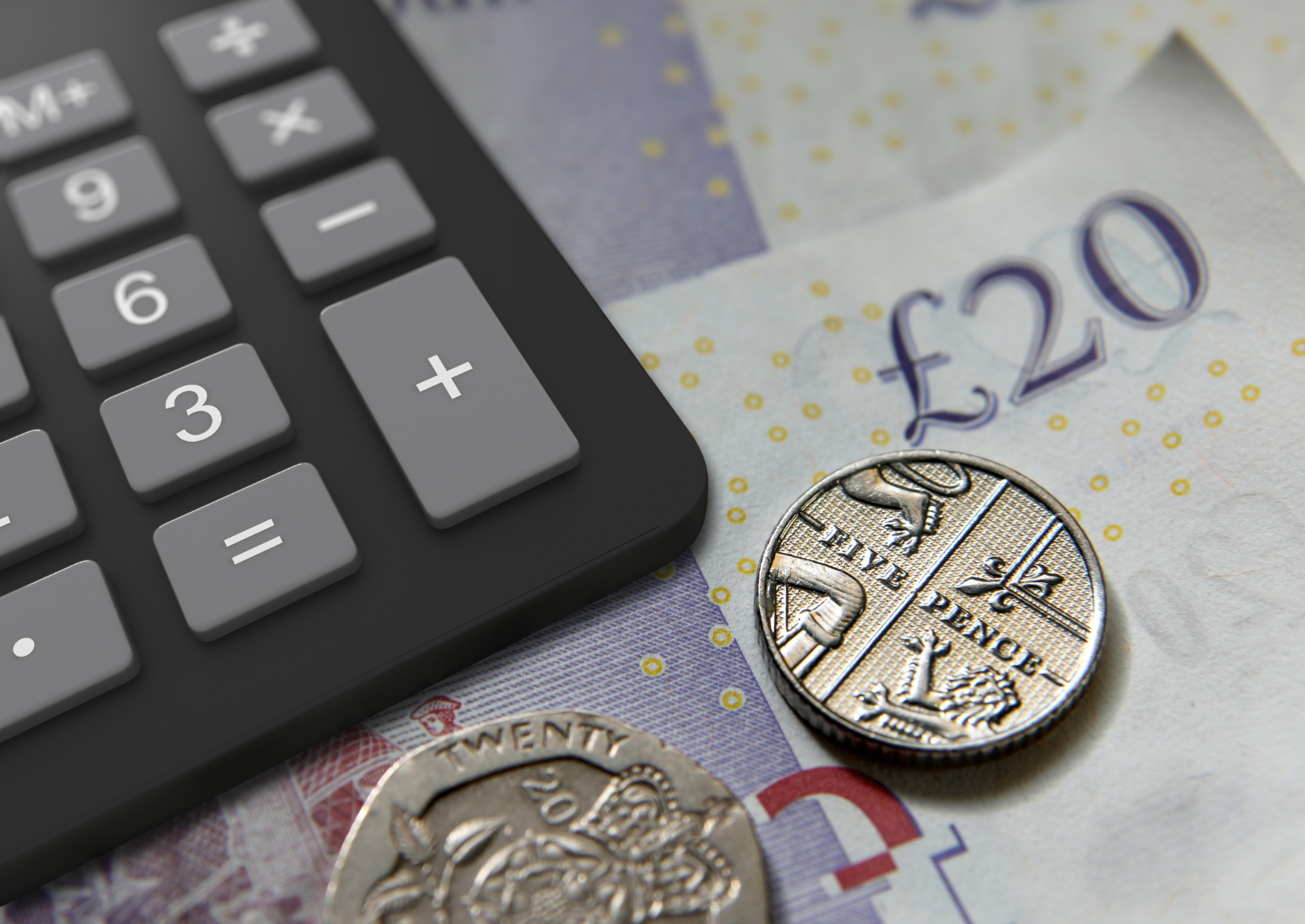 Image of a calculator sat on top of a twenty pound note