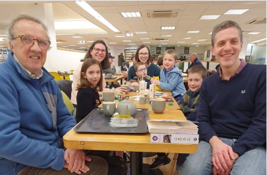 Various people sat around table