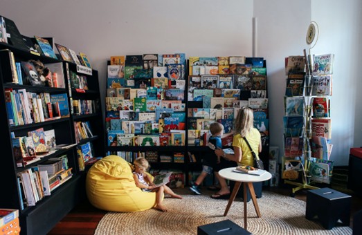 A group of children sitting in a room with books