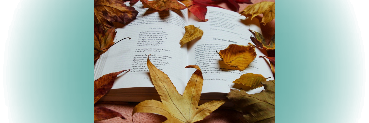 Autumn leaves scattered on a poetry book