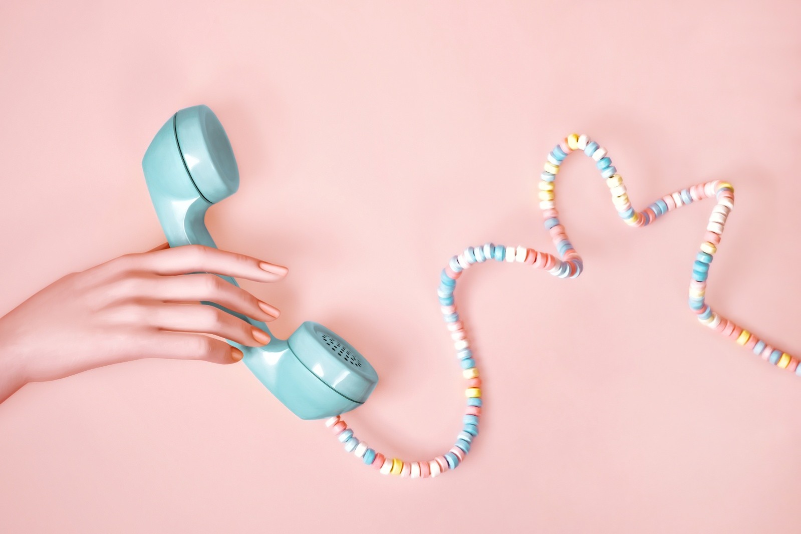 Hand holding a blue telephone