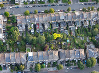 An aerial view of two housing terraces backing onto each other with gardens in between.