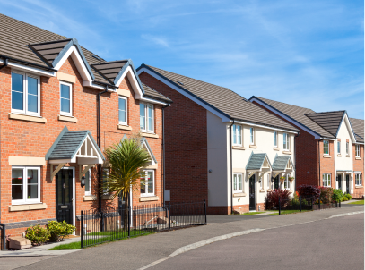 A row of contemporary semi-detached houses in varying styles, fronting onto a pavement and road.