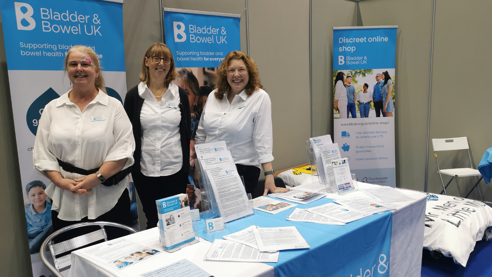 An image of 3 bladder and bowel nurses and specialists at the Kidz to Adultz North event at their stand
