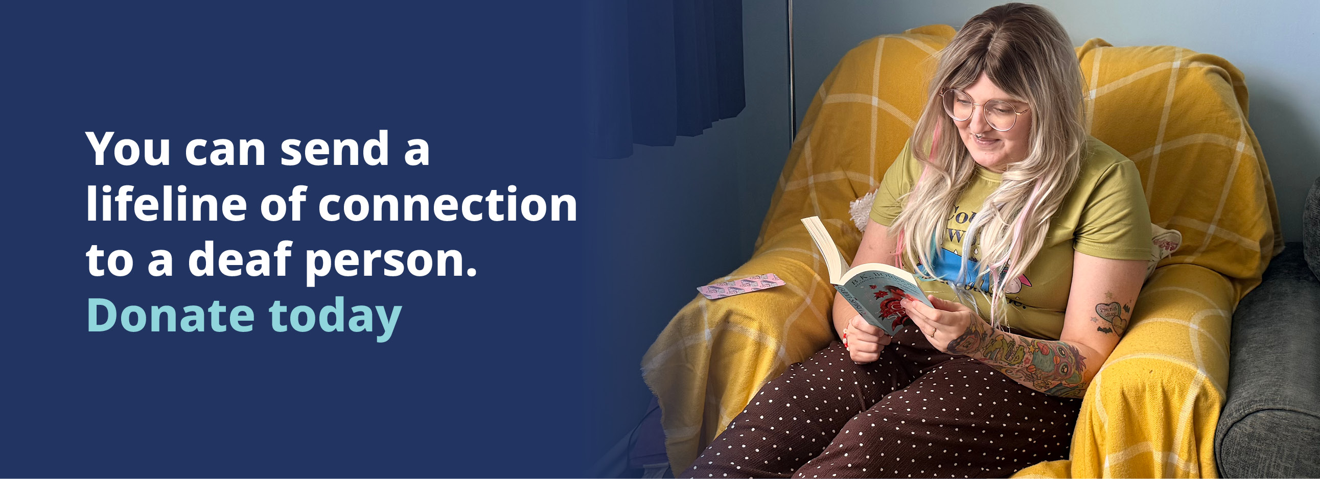 Image of Charlotte, sitting in a yellow chair reading a book. Text reads 'You can send a lifeline of connection to a deaf person. Donate today'.