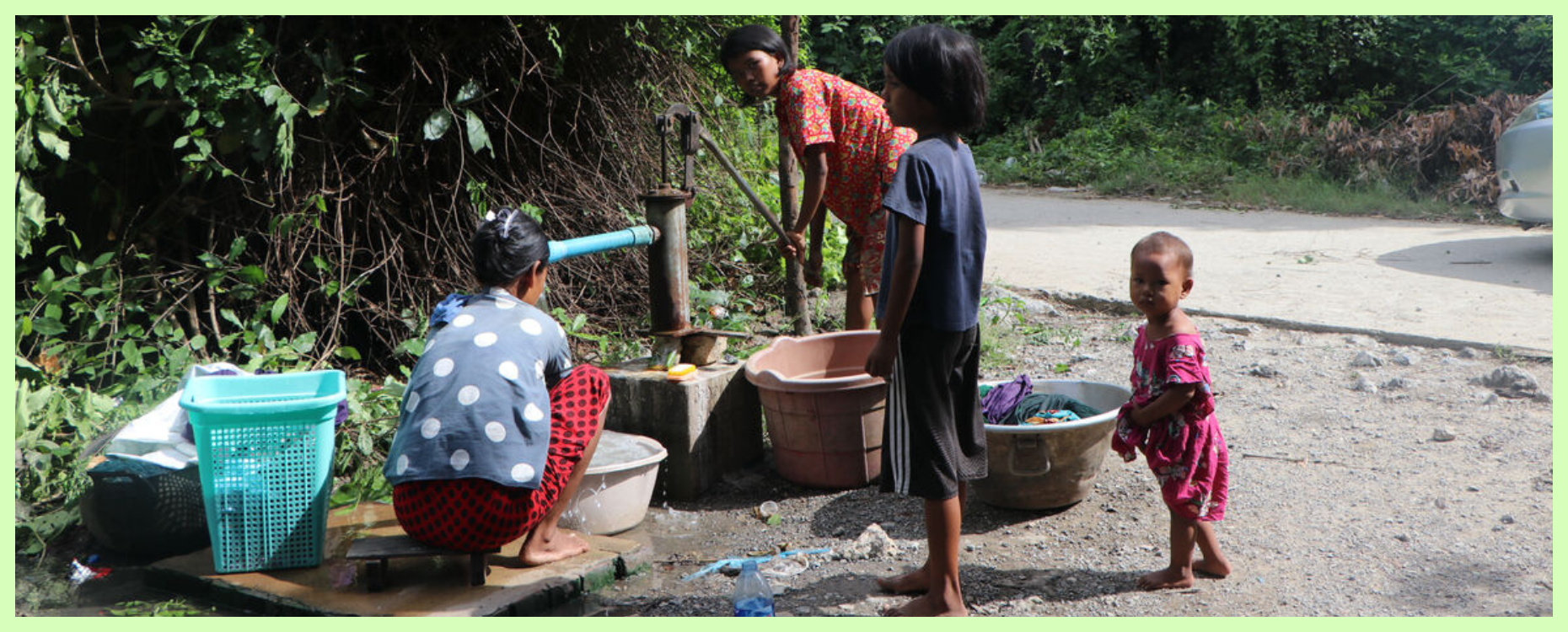 A lady and her family washing clothes